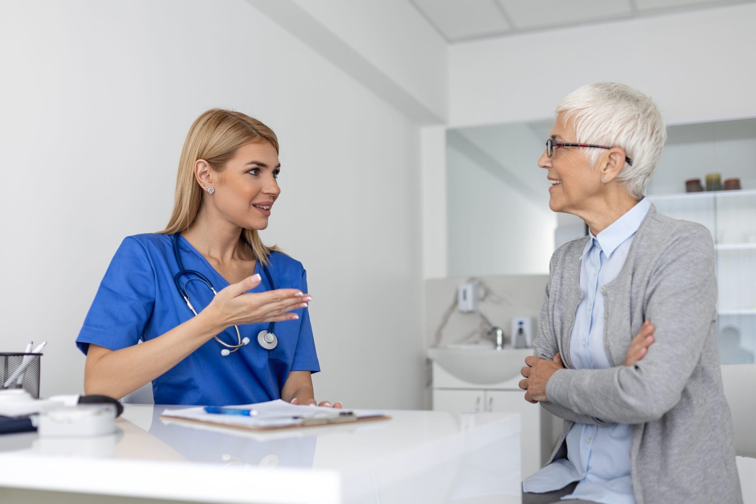 Older adult consulting with healthcare provider about prior authorization for Cyclobenzaprine to relieve muscle spasms.