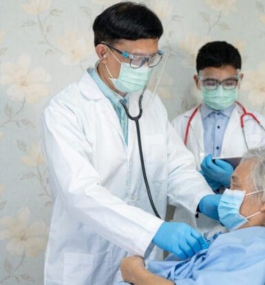 Doctors examining an elderly patient in a healthcare setting, emphasizing personalized diabetes care and medication management.
