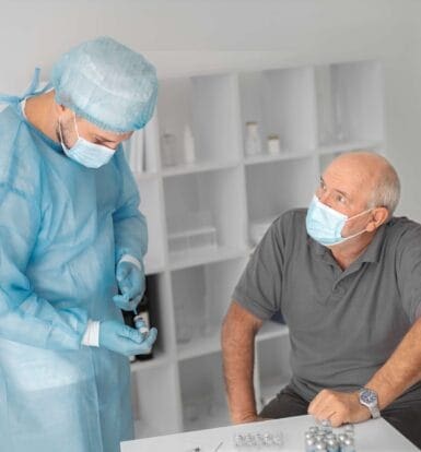 Healthcare provider discussing medication and prior authorization process with a senior male patient during a consultation.