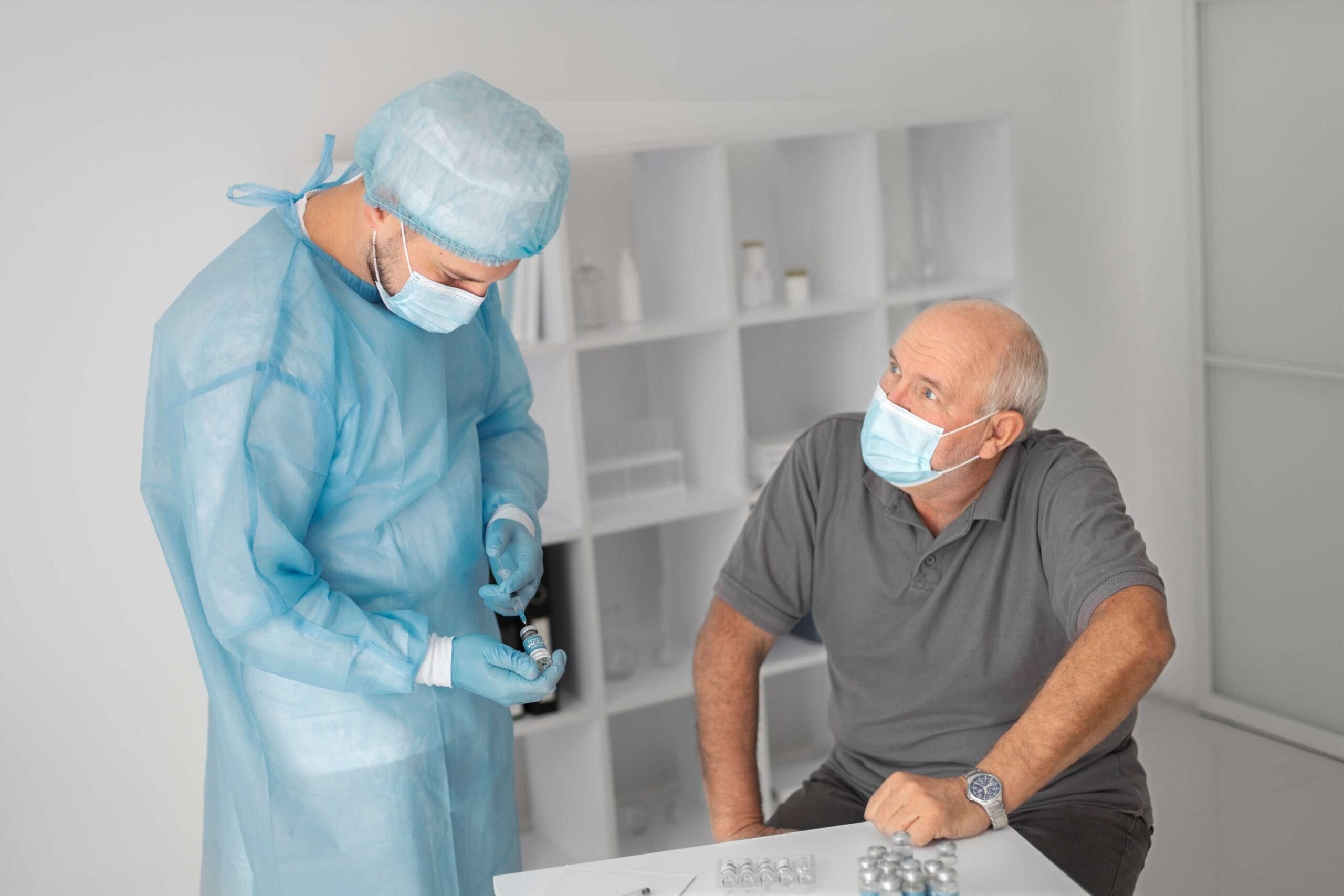 Healthcare provider discussing medication and prior authorization process with a senior male patient during a consultation.