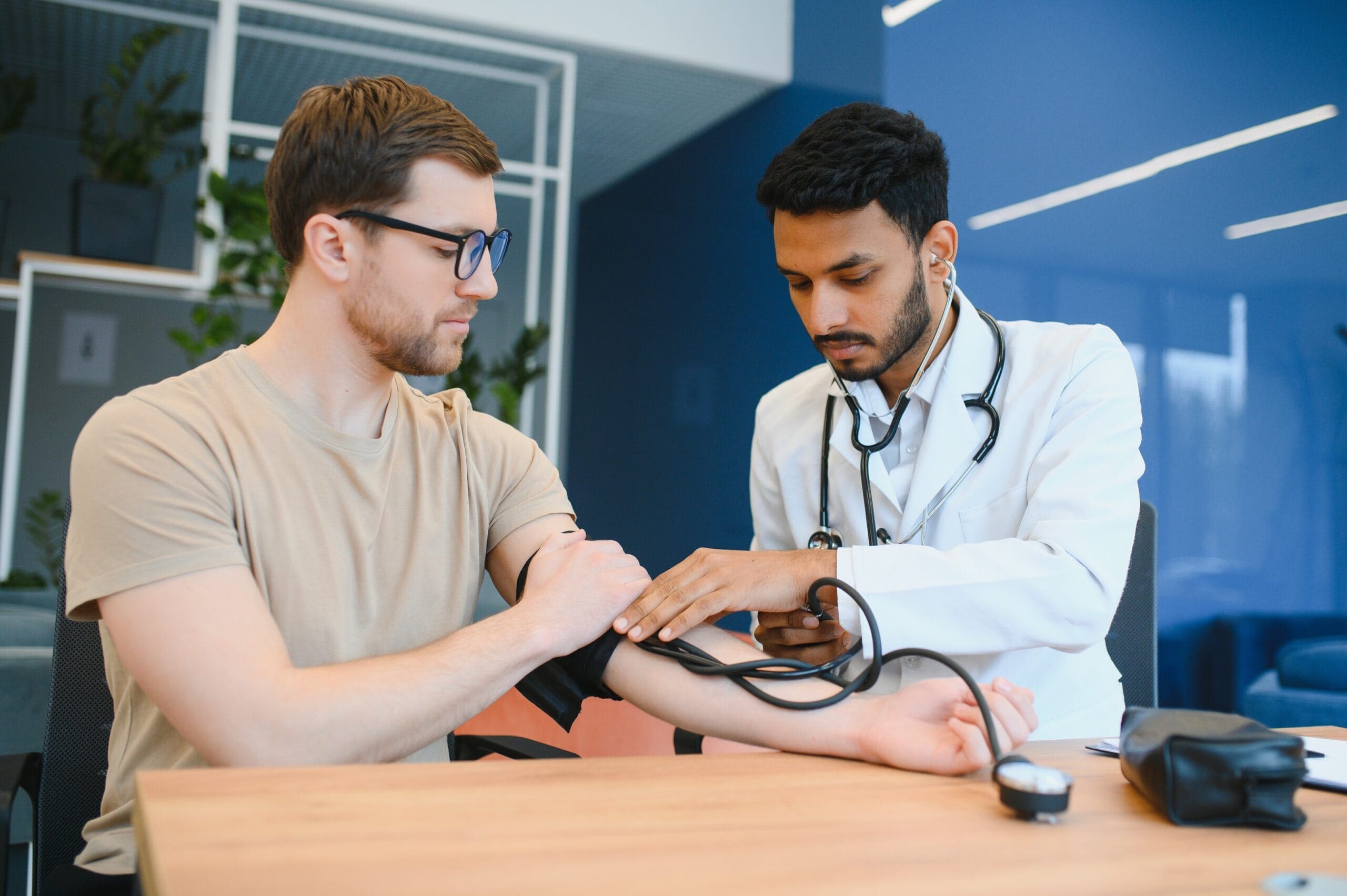 Doctor measuring a patient's blood pressure, illustrating the need for effective hypertension management with medications like Amlodipine Olmesartan.