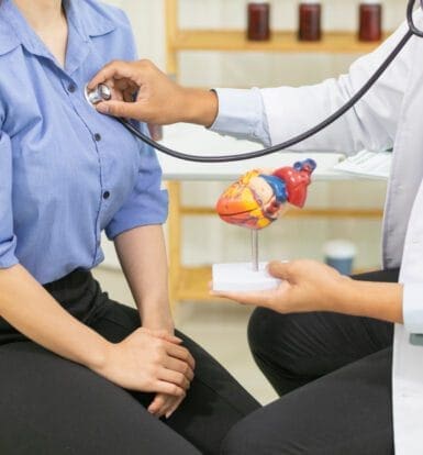 Doctor using a stethoscope to check a patient's heart, symbolizing care for hypertension management with Metoprolol Tartrate