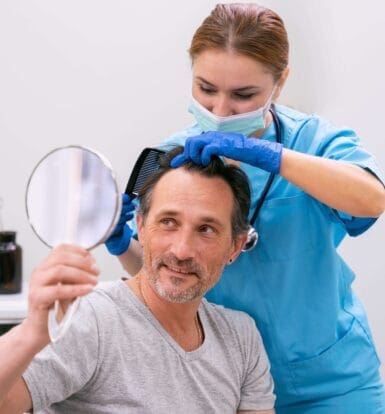 Doctor checking patient's scalp during a consultation, showing concern for hair health and well-being.