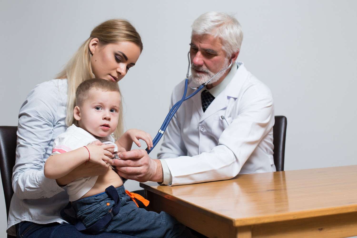 Doctor assessing young child for Dupixent prior authorization.