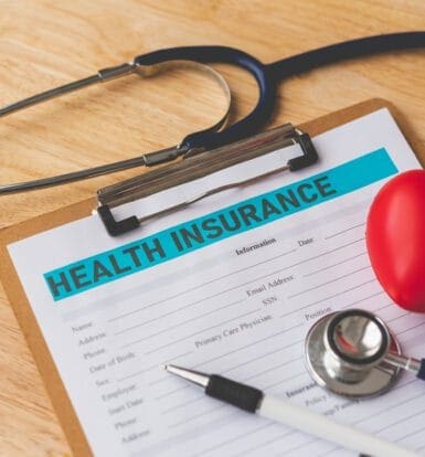 "Insurance entry screen in eClinicalWorks showing fields for policyholder, subscriber number, and co-pay."