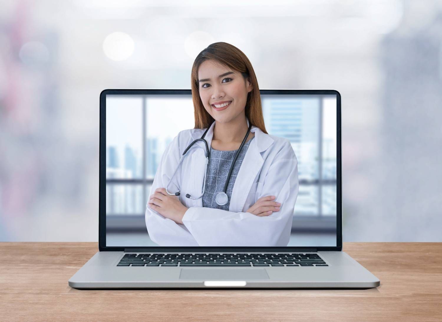 A smiling virtual healthcare assistant in a white coat displayed on a laptop screen, representing remote medical support for practices.