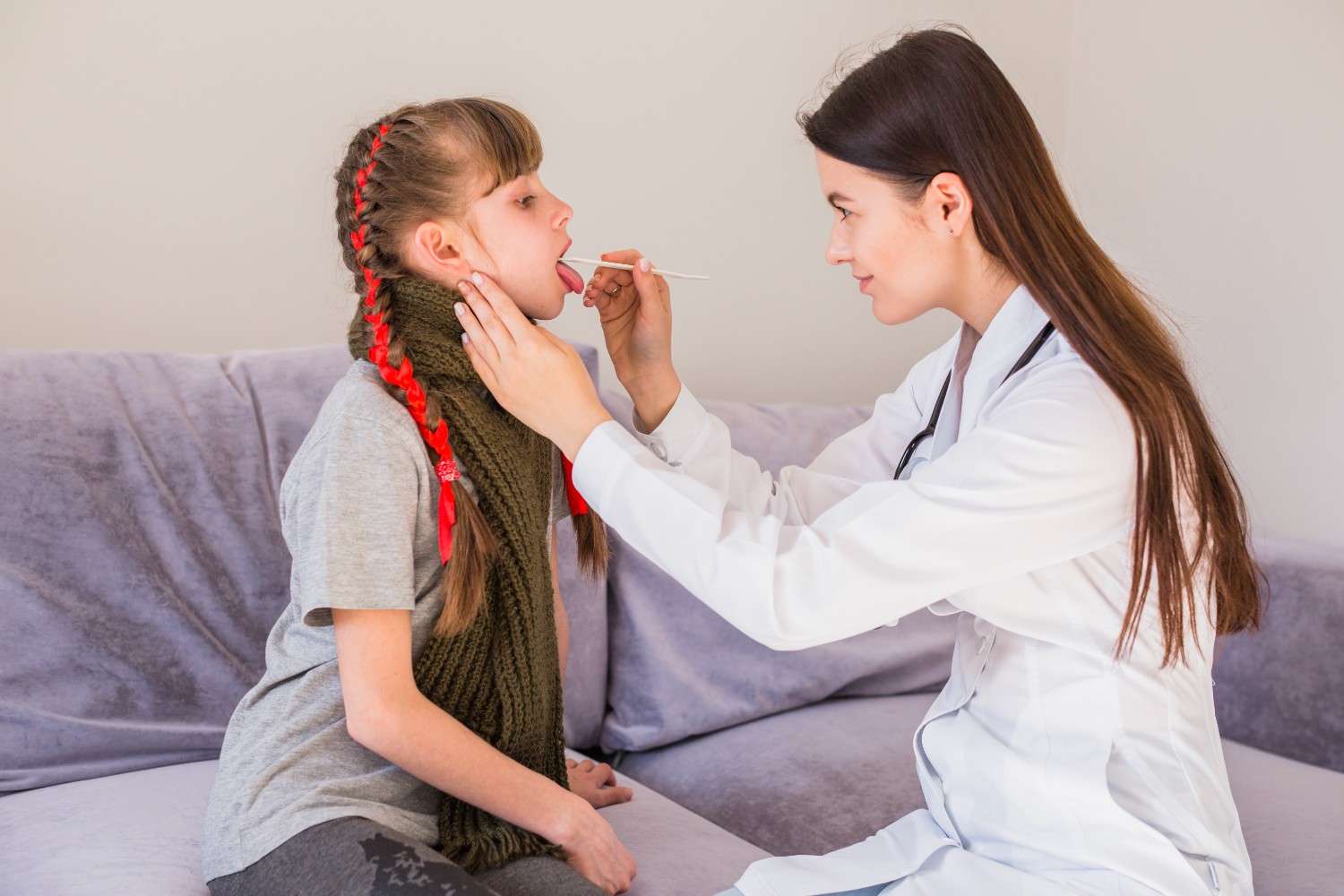 Pediatric doctor performing a medical check-up on a young girl with growth hormone deficiency.