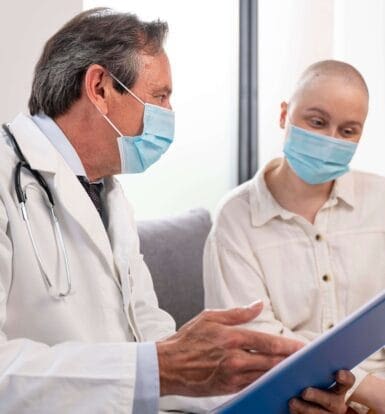 Doctor discussing prior authorization process with a patient in a clinical setting, both wearing masks