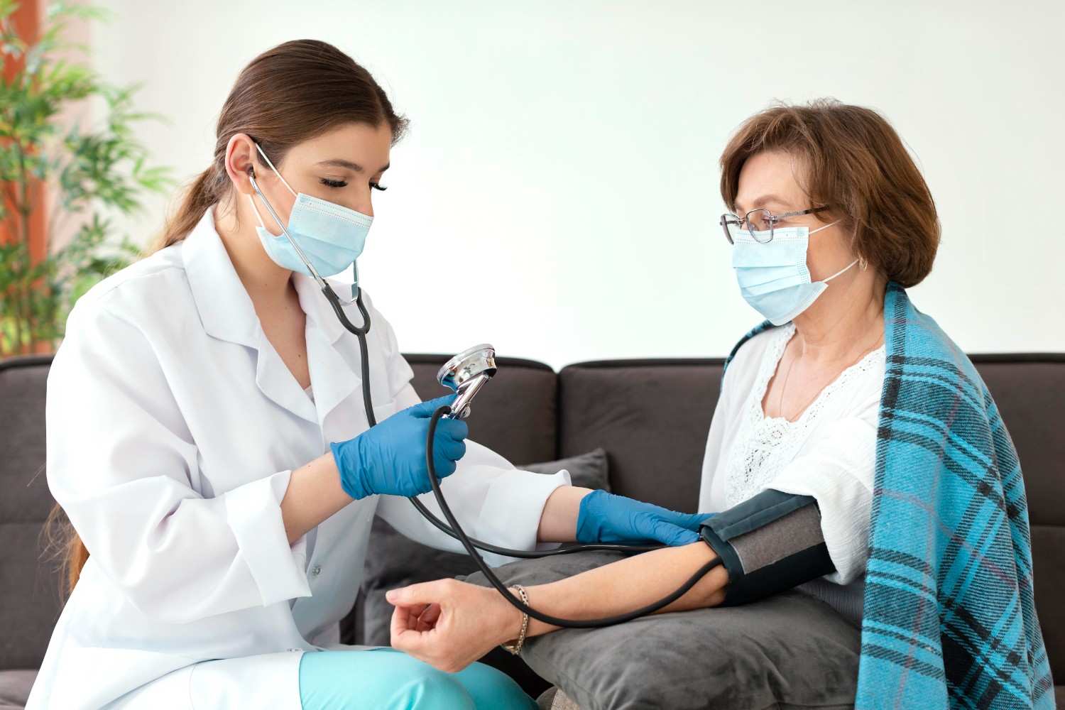 Healthcare provider checking blood pressure of an older female patient during a consultation about prior authorization for medications like Vascepa.