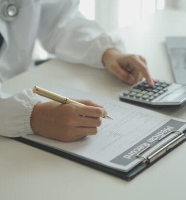 A medical coder analyzing data on a computer to ensure billing accuracy.