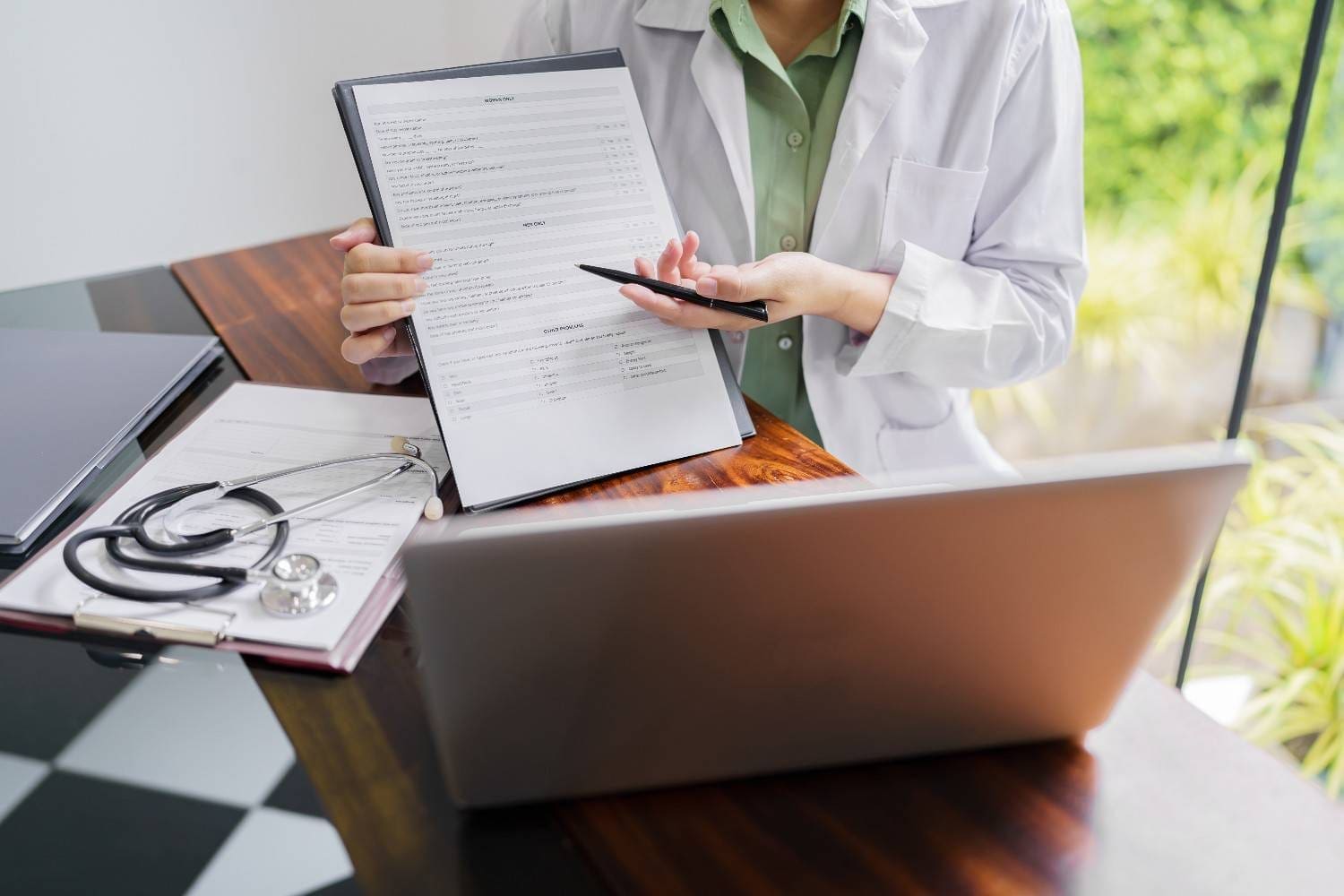 Medical coder reviewing documents for accuracy.