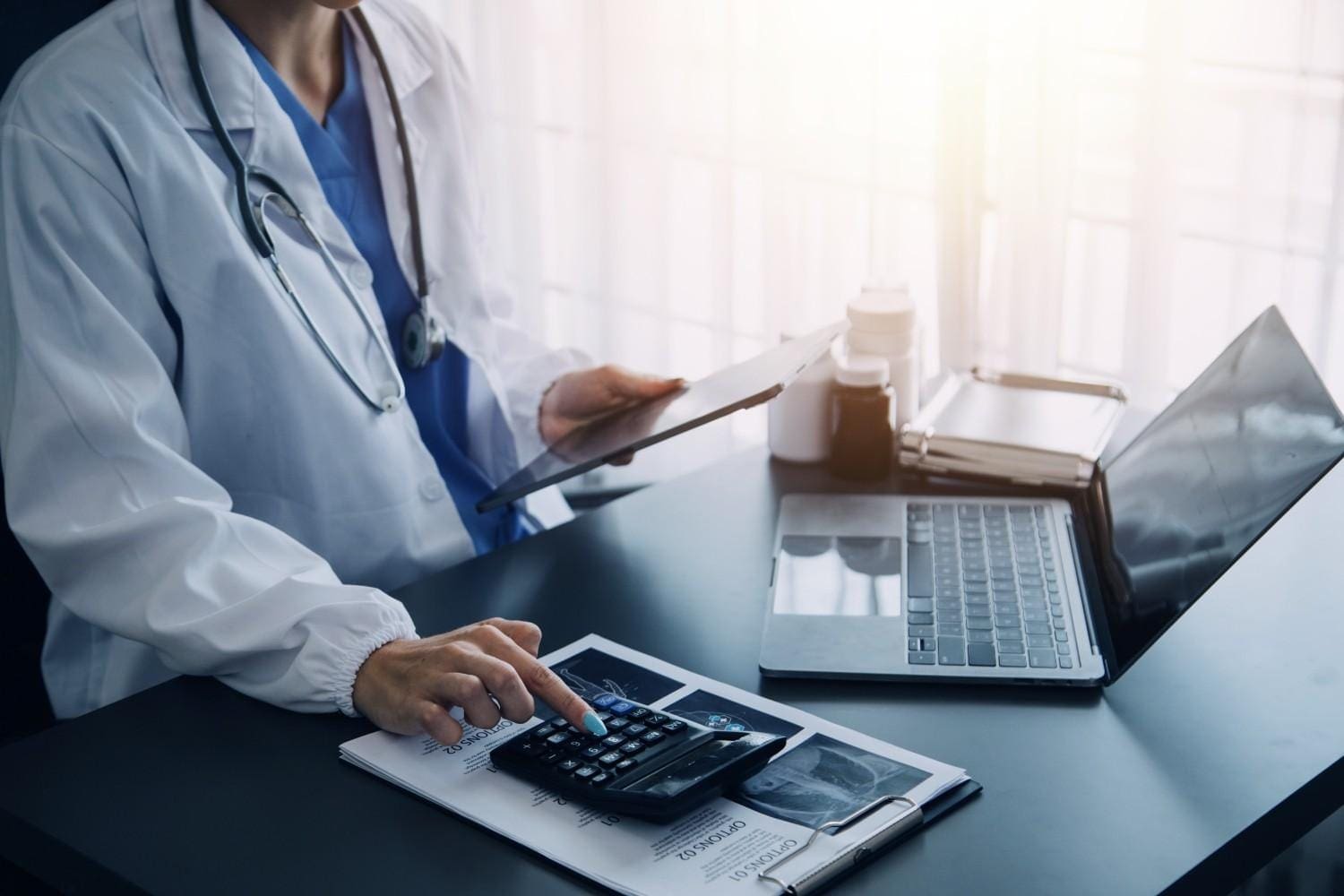 A healthcare provider collaborating with a medical scribe on an EHR system.