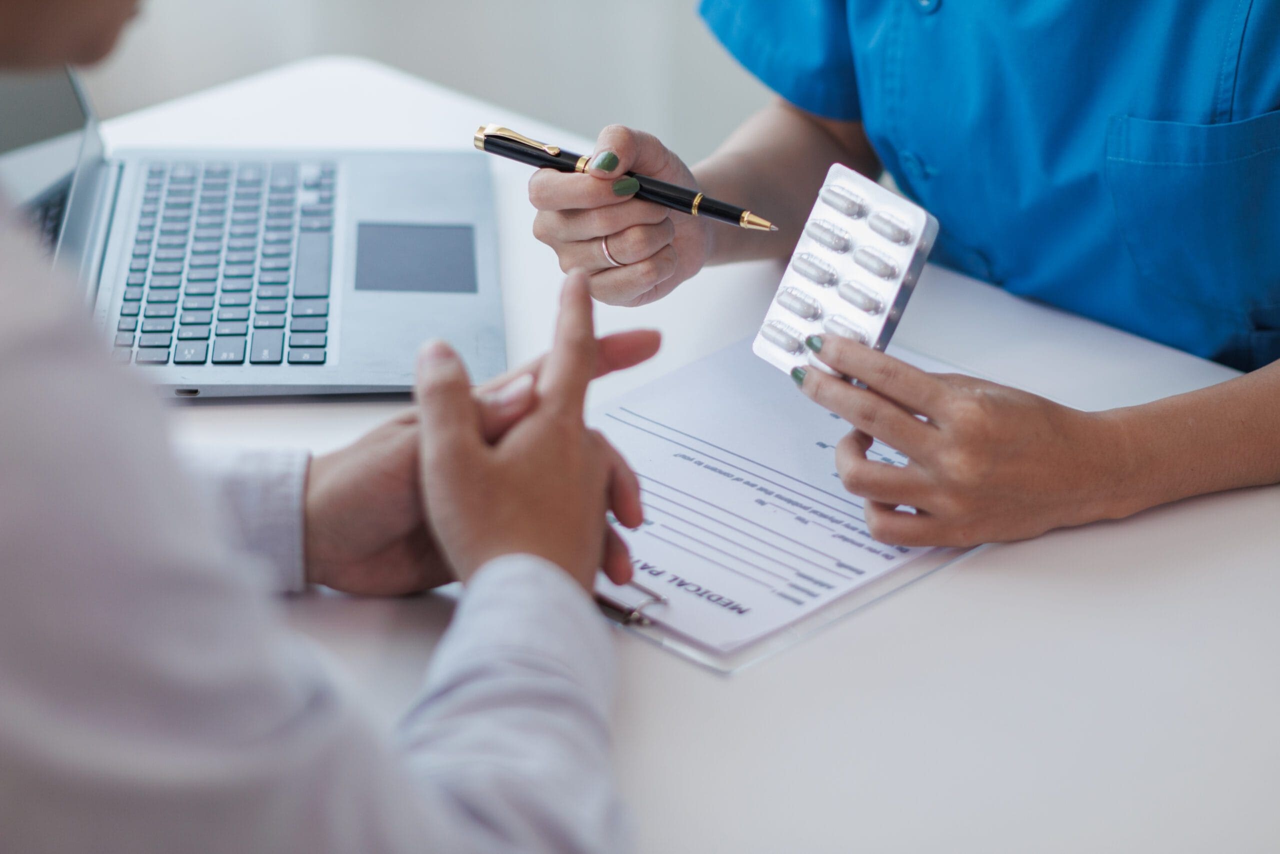 A healthcare professional working on a computer to process prior authorizations.