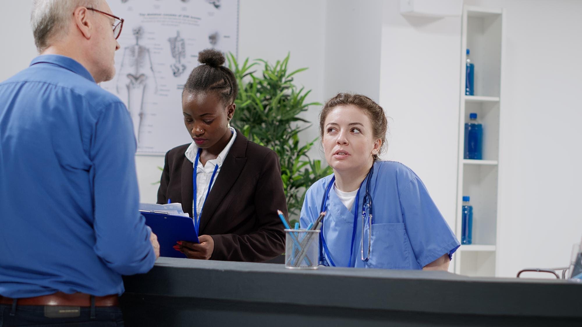 A healthcare worker reviewing billing documents in a busy Bronx clinic.