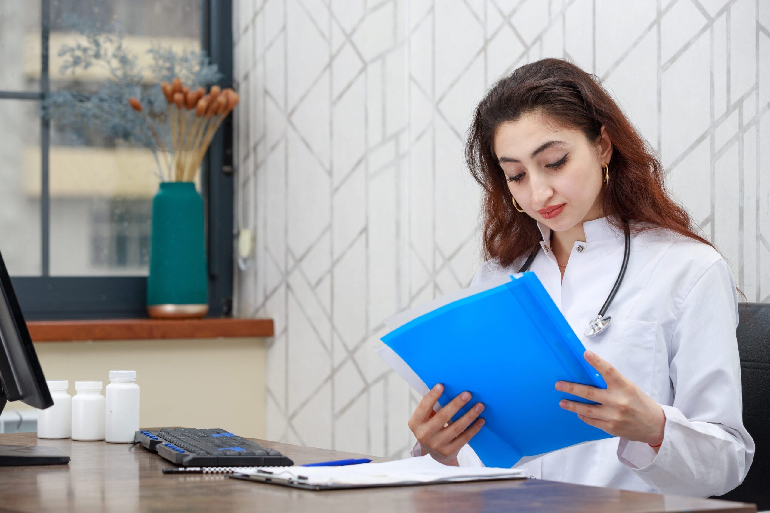 Healthcare provider in Maine reviewing prior authorization documents.