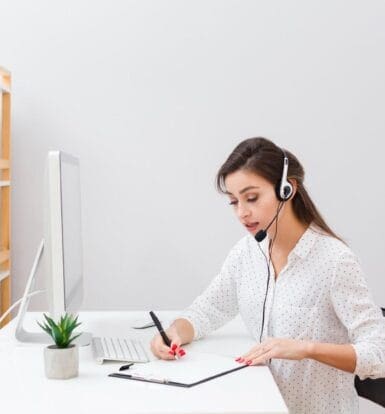 Virtual assistant working remotely for small businesses, handling tasks like customer support and administrative duties with a headset and computer.