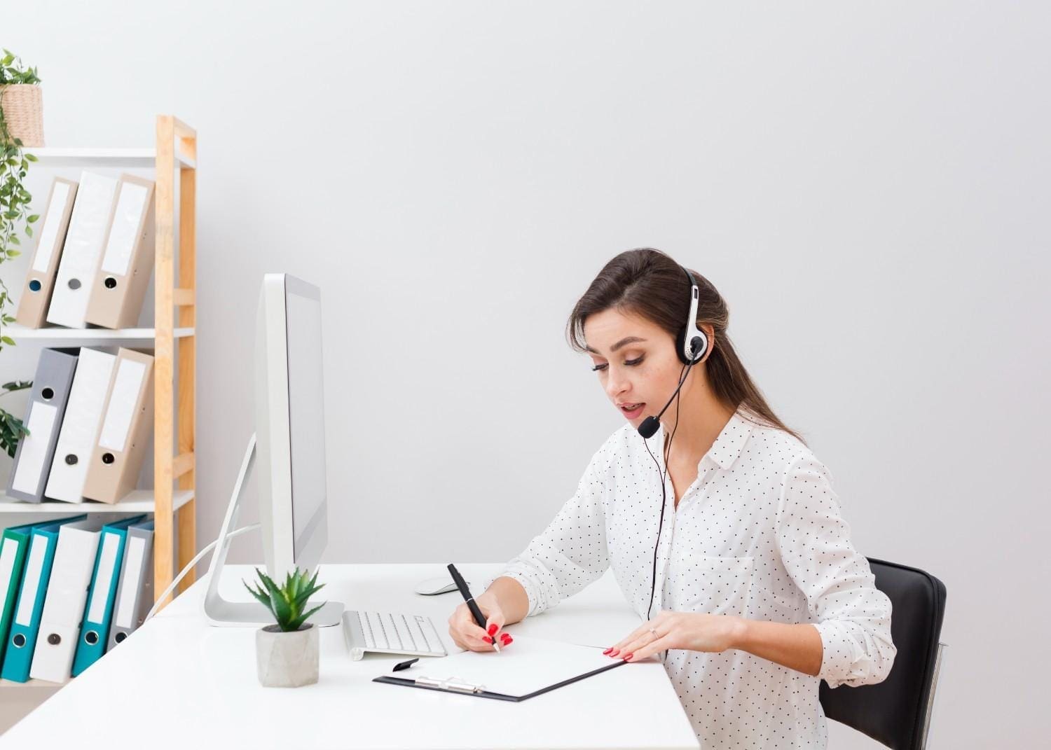 Virtual assistant working remotely for small businesses, handling tasks like customer support and administrative duties with a headset and computer.