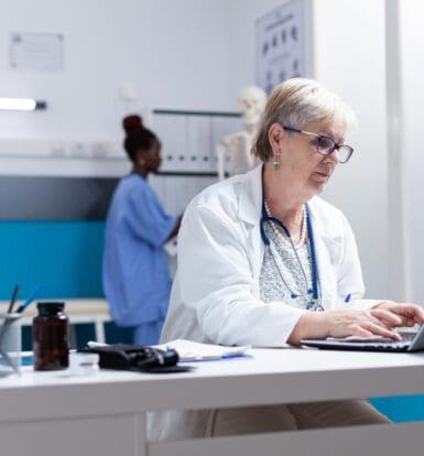 A medical coder reviewing patient records at a Massachusetts clinic.