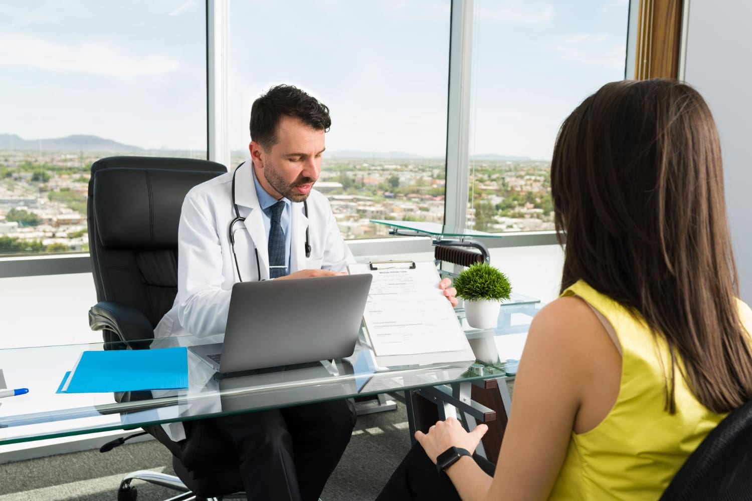 Doctor using a remote medical scribe for EHR documentation.