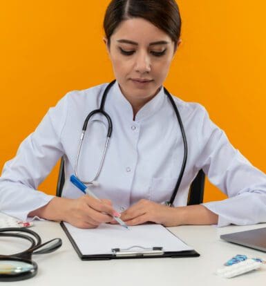 Medical coder reviewing patient data for compliance in New Jersey healthcare office.