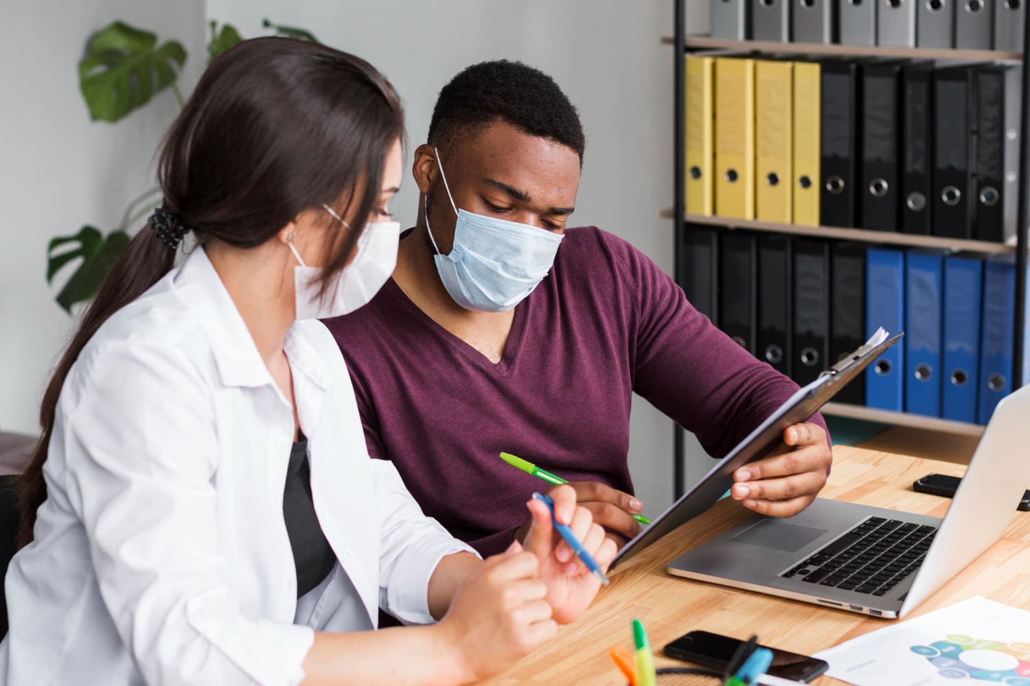 A healthcare professional analyzing medical coding data on a computer screen.
