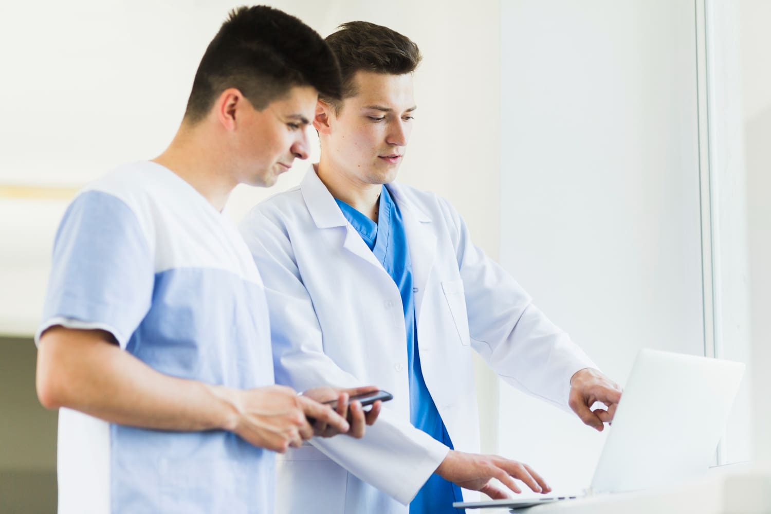 Two healthcare professionals discussing medical coding.