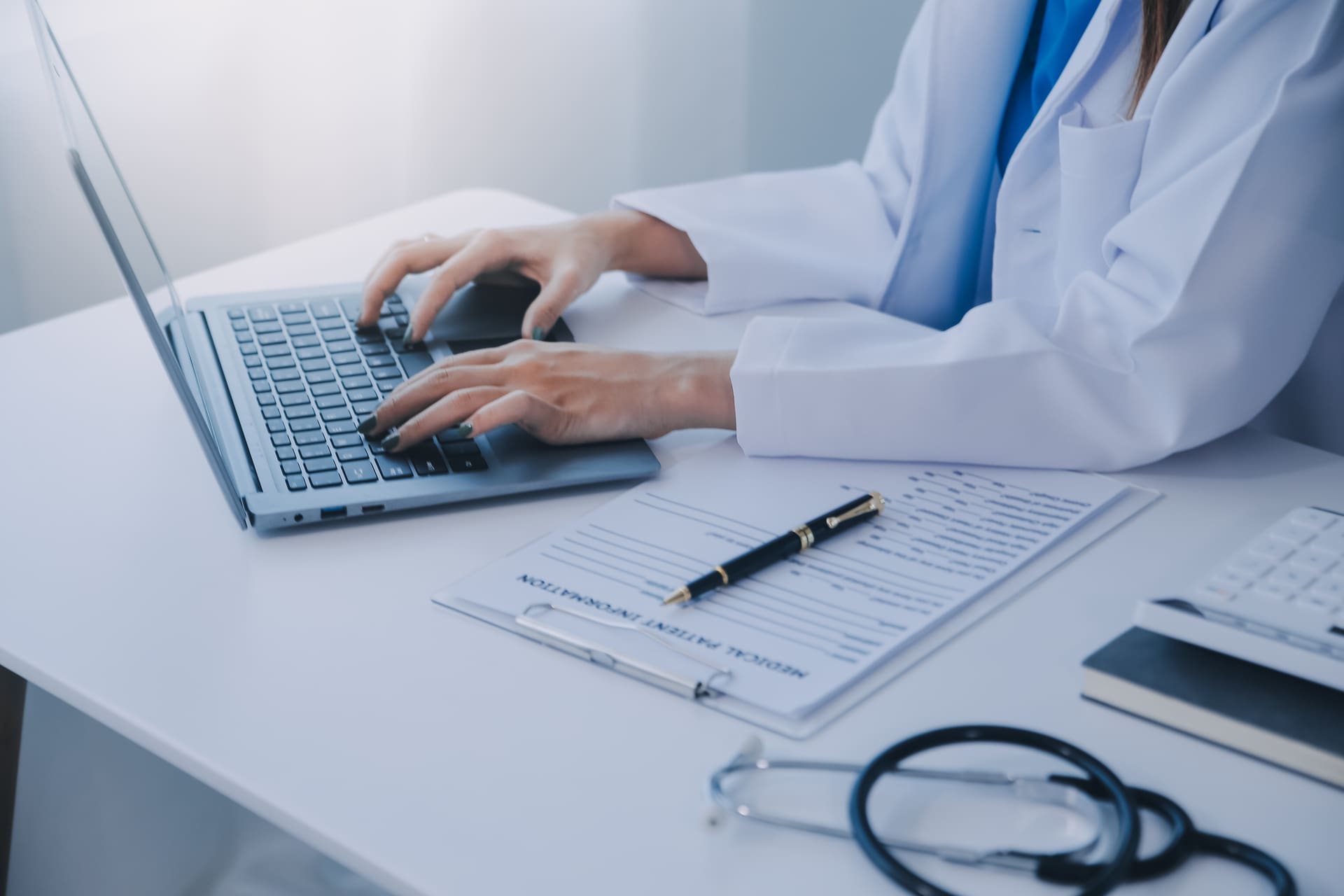A healthcare professional reviewing digital patient records with a focus on HIPAA compliance in medical coding.