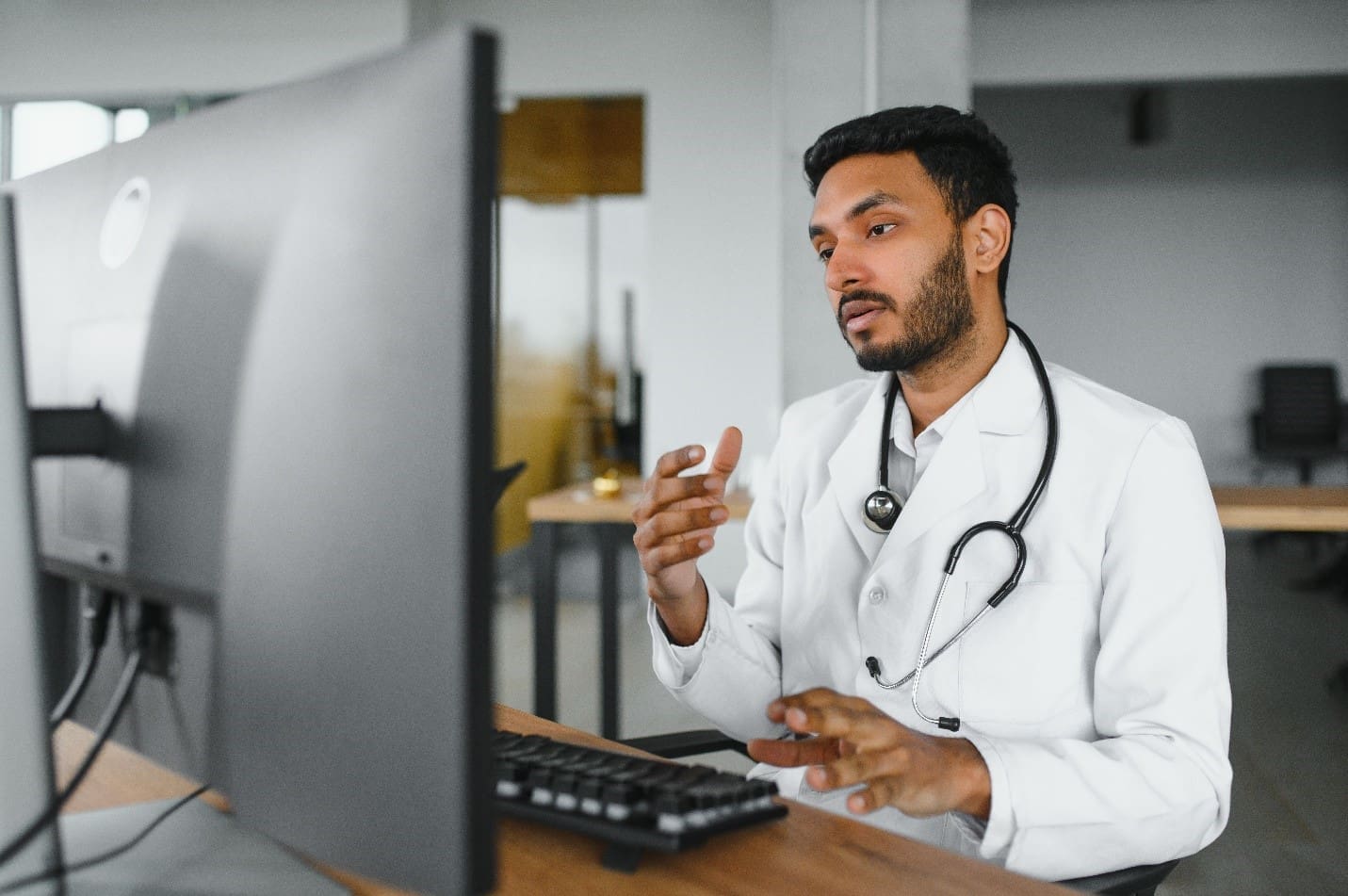 Doctor using a computer for a virtual medical assistant consultation.