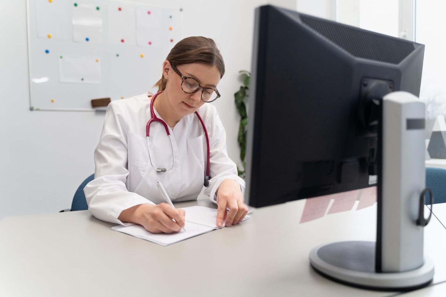 Doctor using Virtual Medical Assistant Services for documentation and patient management.