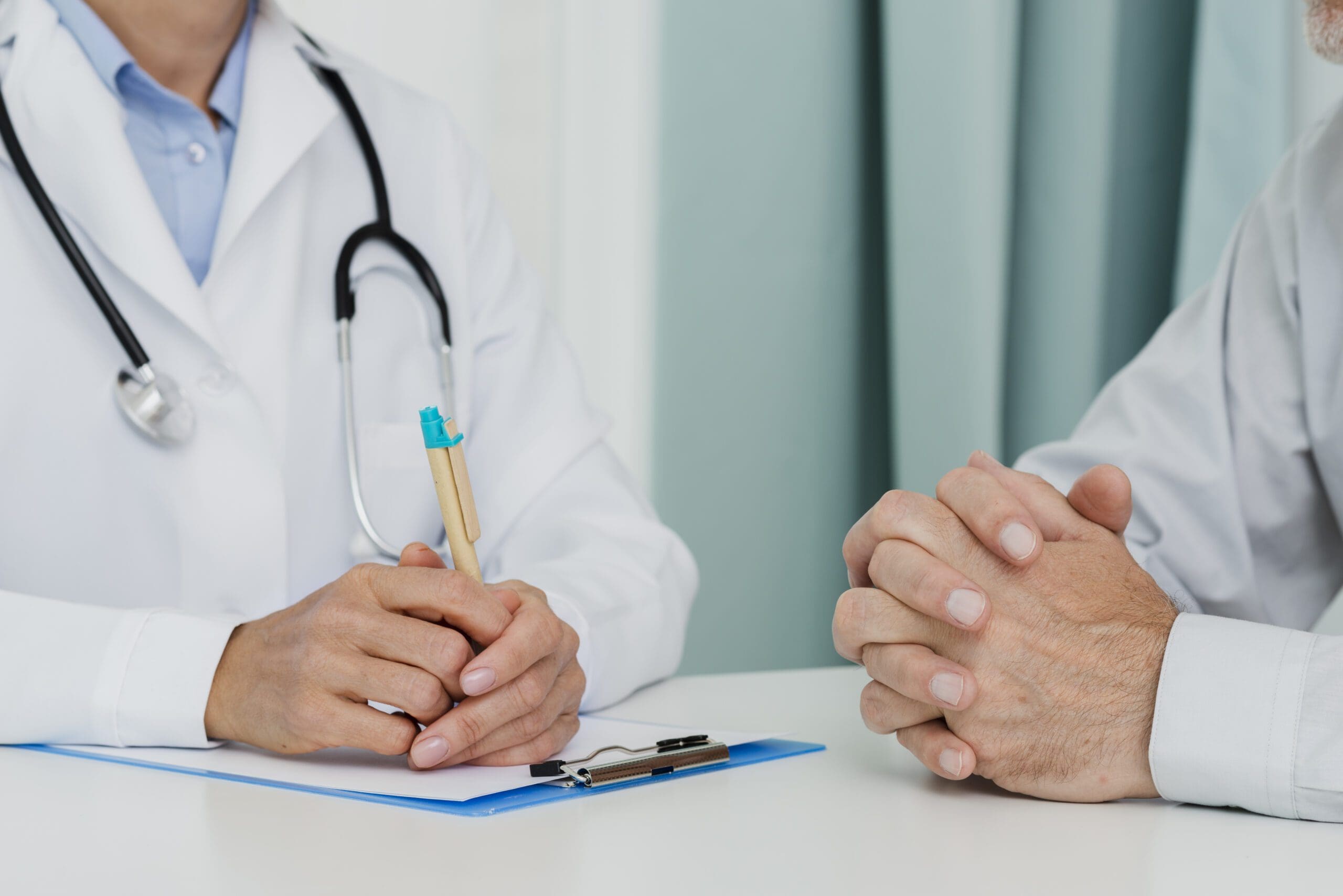 Doctor discussing prior authorization process with patient in medical office